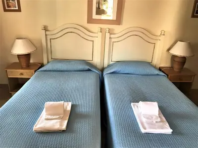 two beds in a bedroom with two towels on them at Old Village in Vilamoura
