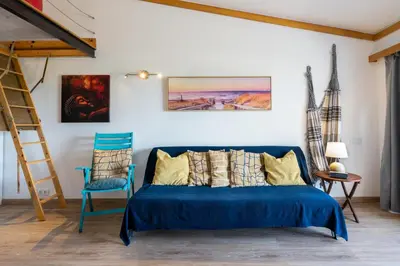 a bedroom with a blue bed and a blue chair at BmyGuest - Quinta do Lago Terrace Apartment I in Quinta do Lago