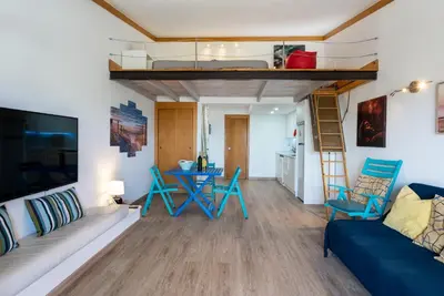 a living room with a couch and a loft bed at BmyGuest - Quinta do Lago Terrace Apartment I in Quinta do Lago