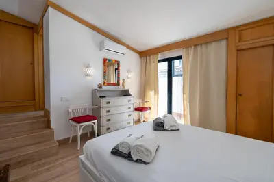 a bedroom with a bed with two towels on it at BmyGuest - Quinta do Lago Terrace Apartment II in Quinta do Lago