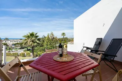 a table with two bottles of wine on a balcony at BmyGuest - Quinta do Lago Terrace Apartment II in Quinta do Lago