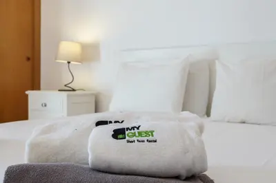 a bedroom with a bed with a pillow on it at BmyGuest - Quinta do Lago Terrace Apartment II in Quinta do Lago
