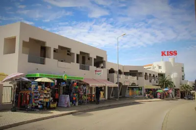 a building with a market in front of a street at Apartamento em Quinta da Barracuda in Albufeira