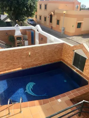 a swimming pool in the middle of a building at Casa das Figuras in Faro