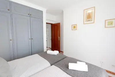 a bedroom with a bed with two towels on it at Pinhal do Golf - Clever Details in Vilamoura