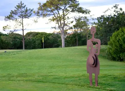 a statue of a woman holding a baby in a field at Pestana Vila Sol - Vilamoura Premium Golf Resort in Vilamoura