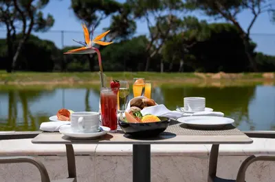 a table with a tray of food and drinks on it at Pestana Vila Sol - Vilamoura Premium Golf Resort in Vilamoura