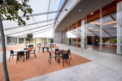 a cafeteria with tables and chairs in a building at Pestana Vila Sol - Vilamoura Premium Golf Resort in Vilamoura