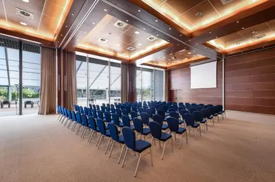 a conference room with chairs and a screen in the middle at Pestana Vila Sol - Vilamoura Premium Golf Resort in Vilamoura