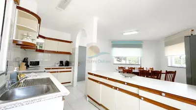 a kitchen with a sink and a counter top at Vila Ricardo by Sunny Deluxe in Albufeira