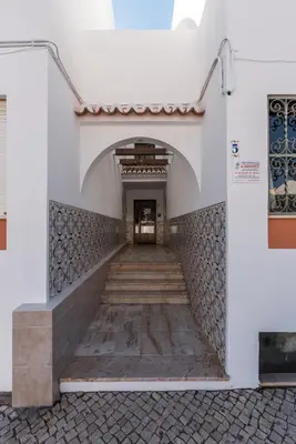 a hallway of a building with a stairway at Casas Barulho Apartments Old Town in Albufeira