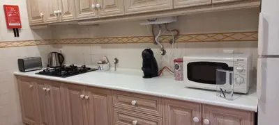 a kitchen counter with a microwave and a stove at Marina de Vilamoura Apart in Vilamoura