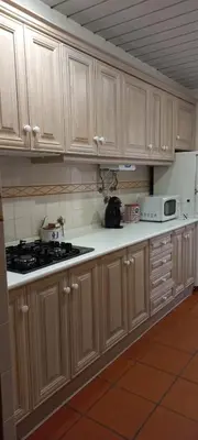 a kitchen with wooden cabinets and a stove top oven at Marina de Vilamoura Apart in Vilamoura