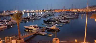 a group of boats docked in a marina at night at Marina de Vilamoura Apart in Vilamoura