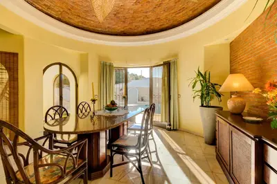 a dining room with a round table and chairs at Villas2go2 V5 Vilamoura XXI in Vilamoura