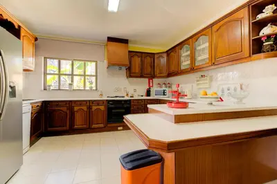 a kitchen with wooden cabinets and a counter top at Villas2go2 V5 Vilamoura XXI in Vilamoura