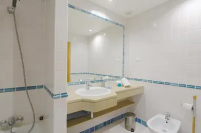 a bathroom with a sink and a mirror at Terraços de Vilamoura 55- Clever Details in Vilamoura