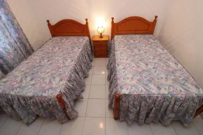 two beds sitting next to each other in a room at Villa Estela in Albufeira