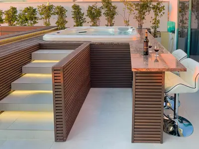 a jacuzzi tub in a room with a bar at Marina Vilamoura Penthouse Aquamar 606 in Vilamoura