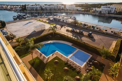 an overhead view of a building with a swimming pool at Marina Vilamoura Penthouse Aquamar 606 in Vilamoura