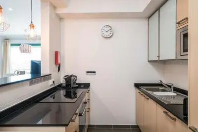 a kitchen with a sink and a clock on the wall at VilamouraSun Aquamar 418 - Vista Marin in Vilamoura