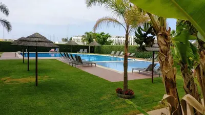 a swimming pool with palm trees and a resort at VilamouraSun Aquamar 418 - Vista Marin in Vilamoura