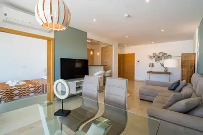 a living room with a couch and a tv and a bed at VilamouraSun Aquamar 418 - Vista Marin in Vilamoura