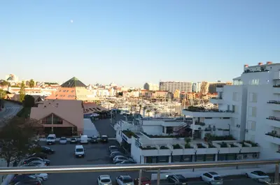 a view of a city with cars parked in a parking lot at VilamouraSun Aquamar 418 - Vista Marin in Vilamoura