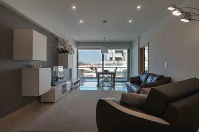 a living room with a couch and a kitchen at Aquamar 416 by Vilamoura Sun - espaçoso, in Vilamoura