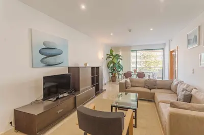 a living room with a couch and a tv at Marina Vilamoura - Aquamar 215 - VilamouraSun in Vilamoura