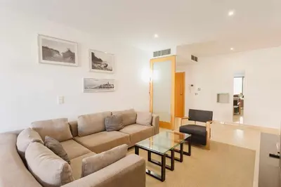 a living room with a couch and a glass table at Marina Vilamoura - Aquamar 215 - VilamouraSun in Vilamoura
