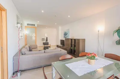 a living room with a couch and a table at Marina Vilamoura - Aquamar 215 - VilamouraSun in Vilamoura