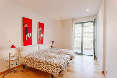 a bedroom with a bed and two posters on the wall at Marina Vilamoura - Aquamar 215 - VilamouraSun in Vilamoura