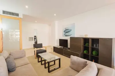 a living room with a couch and a tv at Marina Vilamoura - Aquamar 215 - VilamouraSun in Vilamoura