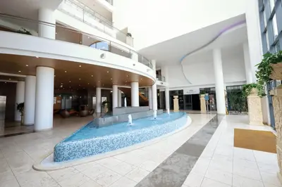 a large swimming pool in a building with a light on the ceiling at Grand Muthu Forte do Vale in Albufeira