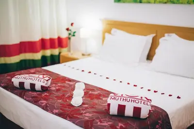 a living room with a red couch and a table at Grand Muthu Forte do Vale in Albufeira