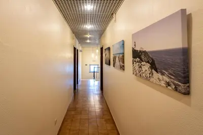 a hallway with pictures on the walls of a building at Guest House Oliveira in Boliqueime