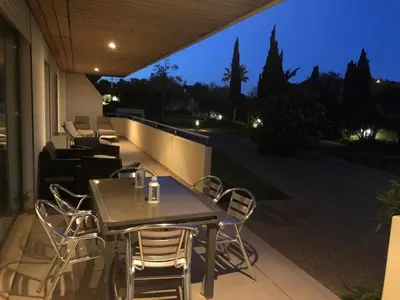 a table and chairs on a balcony at night at Marina Vilamoura - Aquamar 012 - by VilamouraSun in Vilamoura