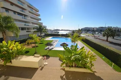 a swimming pool in front of a building at Marina Vilamoura - Aquamar 012 - by VilamouraSun in Vilamoura