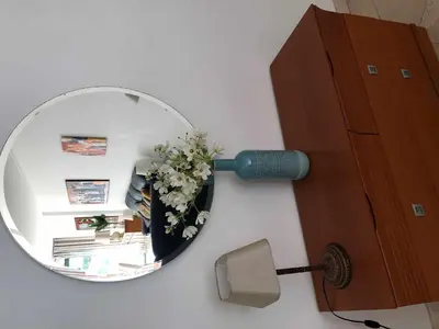 a mirror on a wall with a lamp and flowers at Marina Vilamoura - Aquamar 012 - by VilamouraSun in Vilamoura