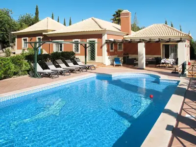 a swimming pool in front of a house at Holiday Home Montinho by Interhome in Loulé