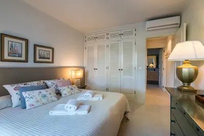 a bedroom with a bed with two towels on it at Solar do Golfe apt 101 - By Vilamoura Sun in Vilamoura