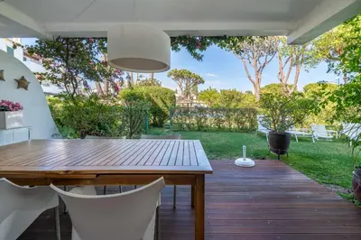 a wooden table and chairs on a wooden deck at Solar do Golfe apt 101 - By Vilamoura Sun in Vilamoura