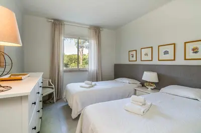 a bedroom with two beds and a desk and a window at Solar do Golfe apt 101 - By Vilamoura Sun in Vilamoura