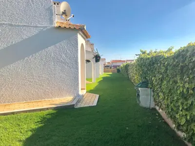 a fence next to a building with green grass at VILAMOURA FÉRIAS by Ethnic Ocean in Vilamoura