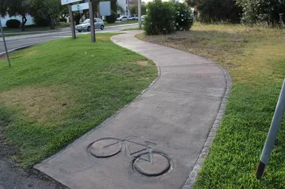 a bike laying on the side of a sidewalk at VILAMOURA FÉRIAS by Ethnic Ocean in Vilamoura