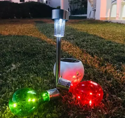 two wine bottles with christmas lights on the grass at VILAMOURA FÉRIAS by Ethnic Ocean in Vilamoura