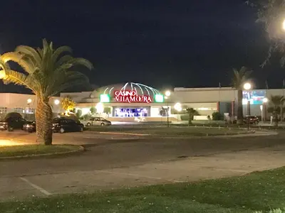 a building with a coca cola sign at night at VILAMOURA FÉRIAS by Ethnic Ocean in Vilamoura