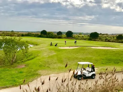 a golf cart parked on a golf course at VILAMOURA FÉRIAS by Ethnic Ocean in Vilamoura