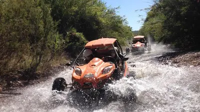 an orange vehicle driving through a water logged road at Marina Vilamoura - Aquamar 315 by Vilamoura Sun in Vilamoura
